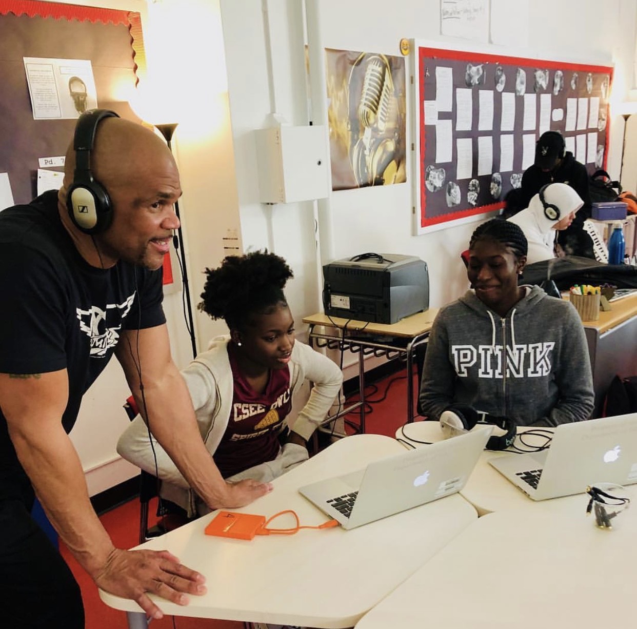 Clinton music production mentor working with students on laptops