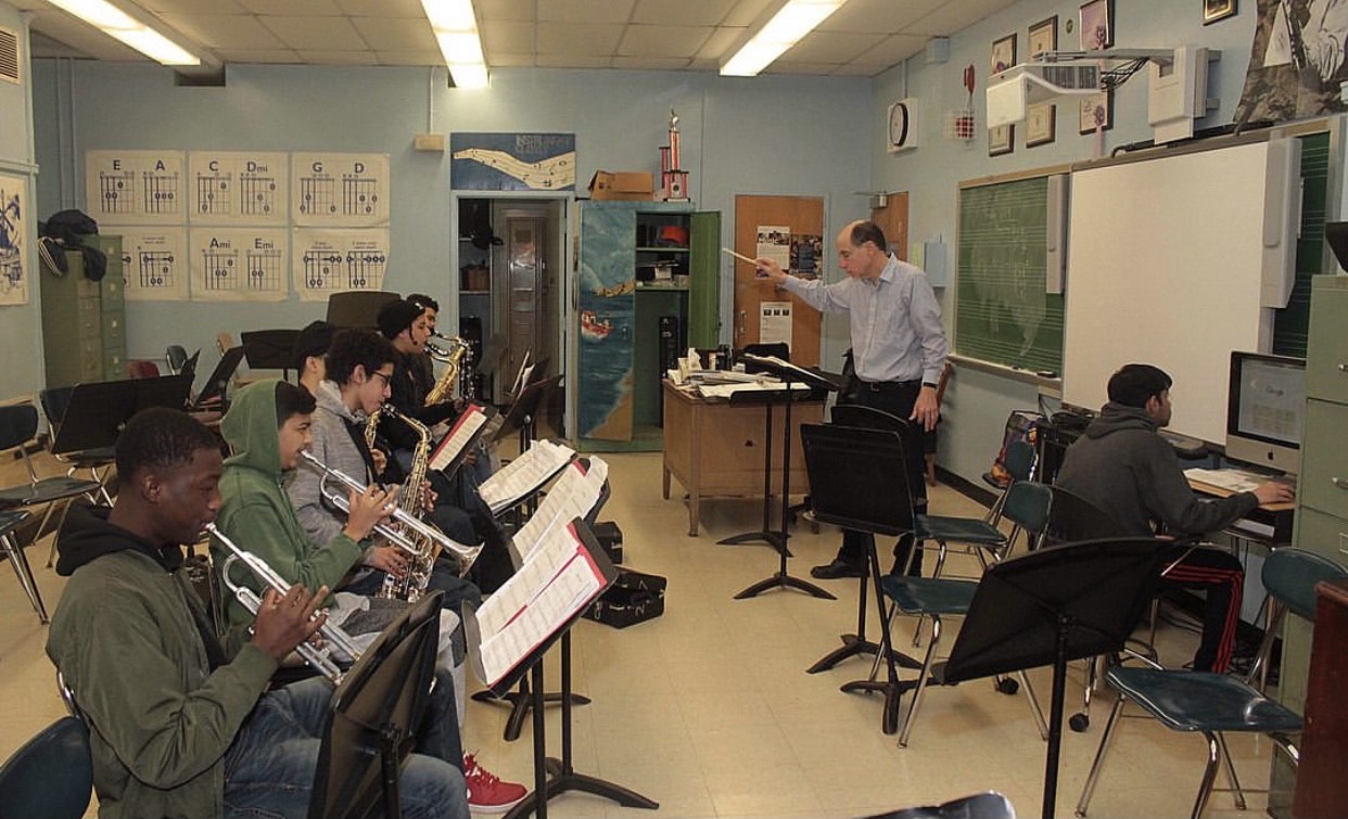 Clinton band class rehearsing with their conductor